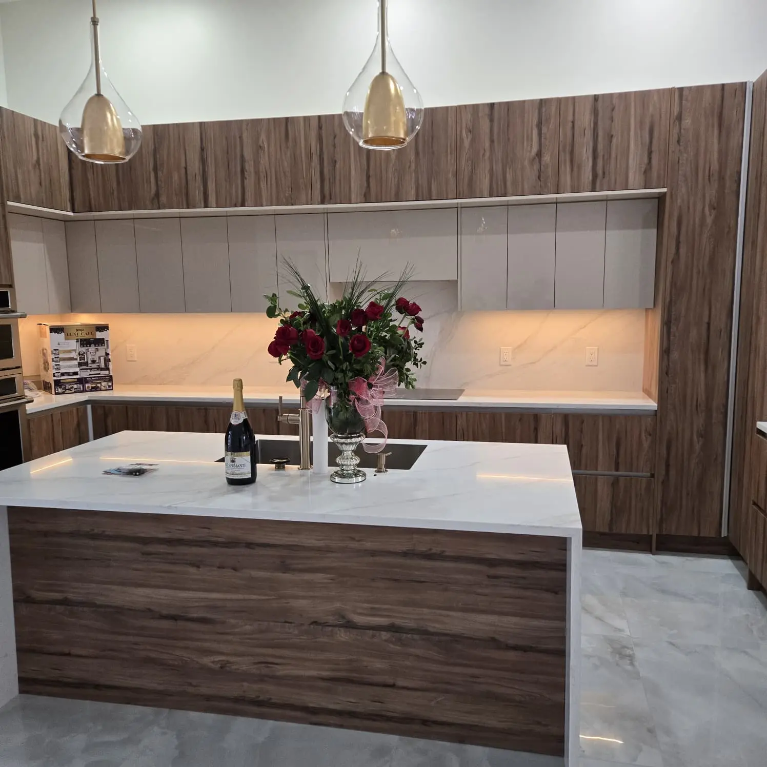 Walnut and matte taupe custom kitchen with white island countertop