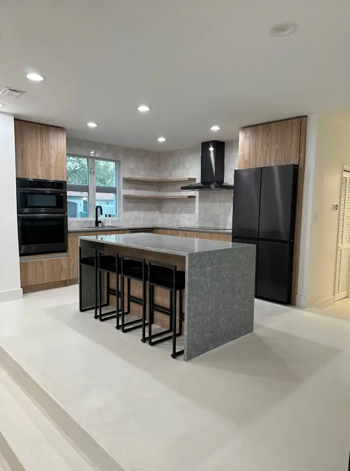 Two-tone modern kitchen with wood cabinetry and dark island