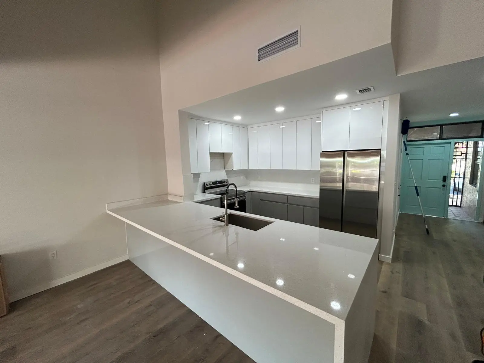 Bright white kitchen with waterfall island countertop