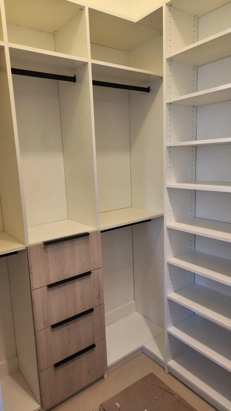 White and oak walk-in closet with open shelving and drawers